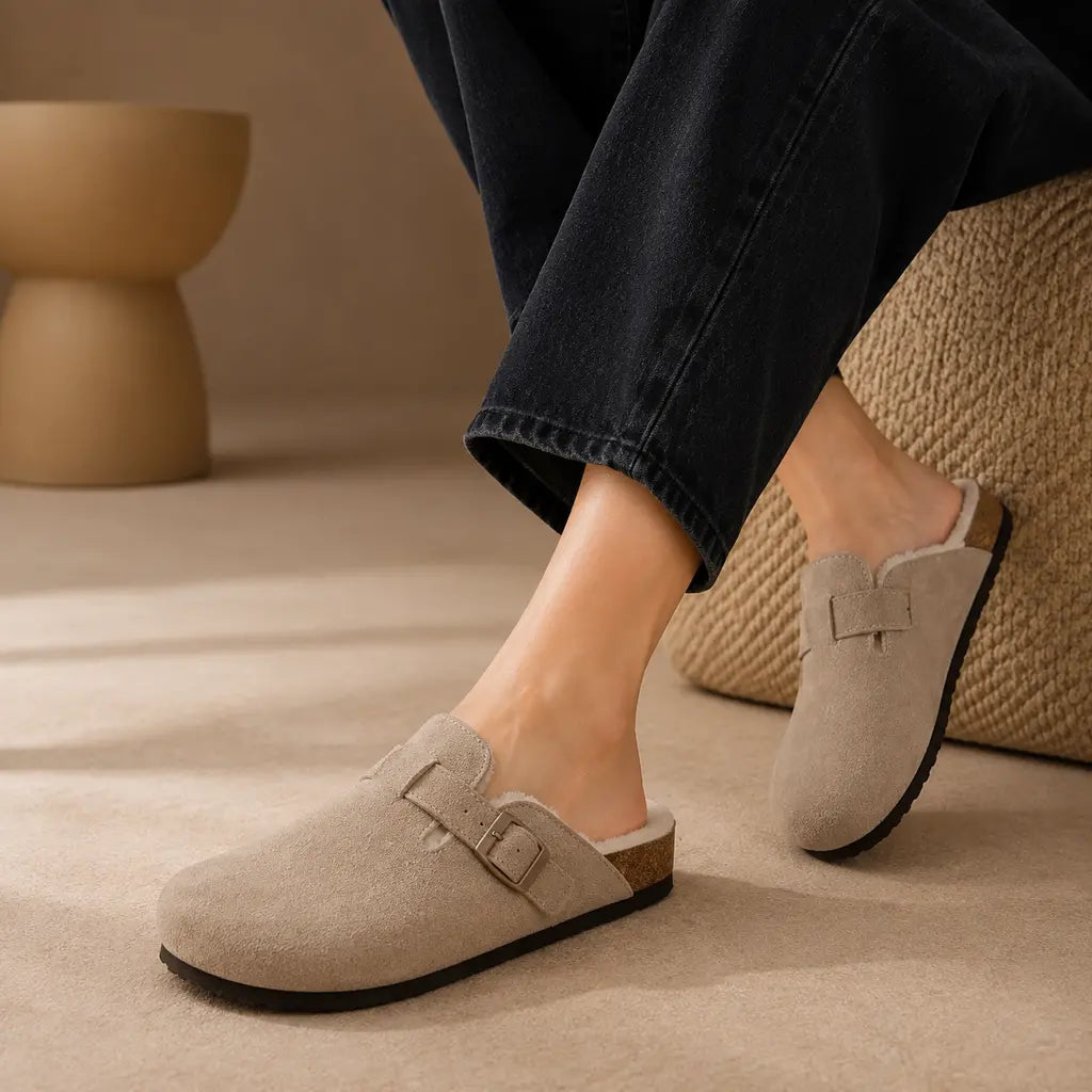 Taupe genuine suede fur-lined clogs worn with black jeans