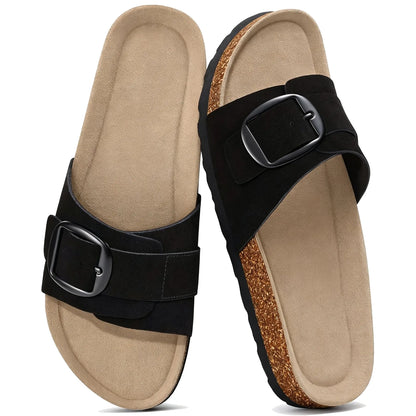 Black suede slide sandals with wide strap and buckle, pair top view