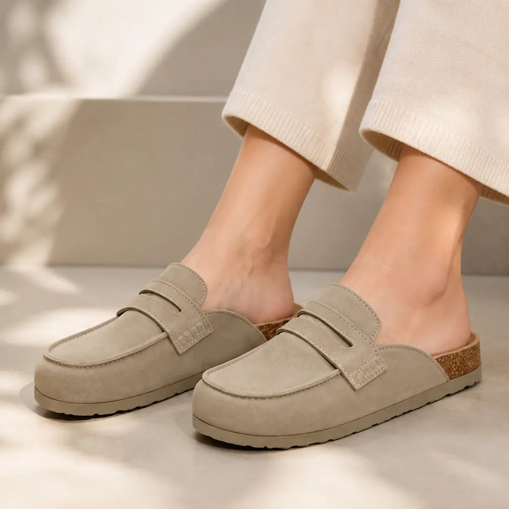 Taupe suede clog mules worn with cream trousers