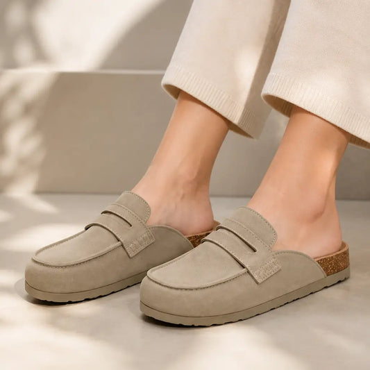 Taupe suede clog mules worn with cream trousers
